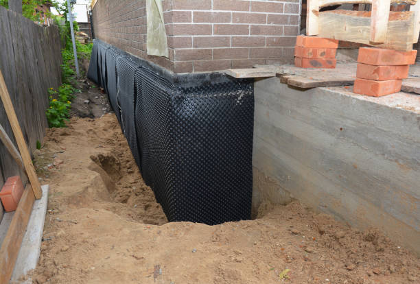 Happy homeowners after waterproofing job in Munford